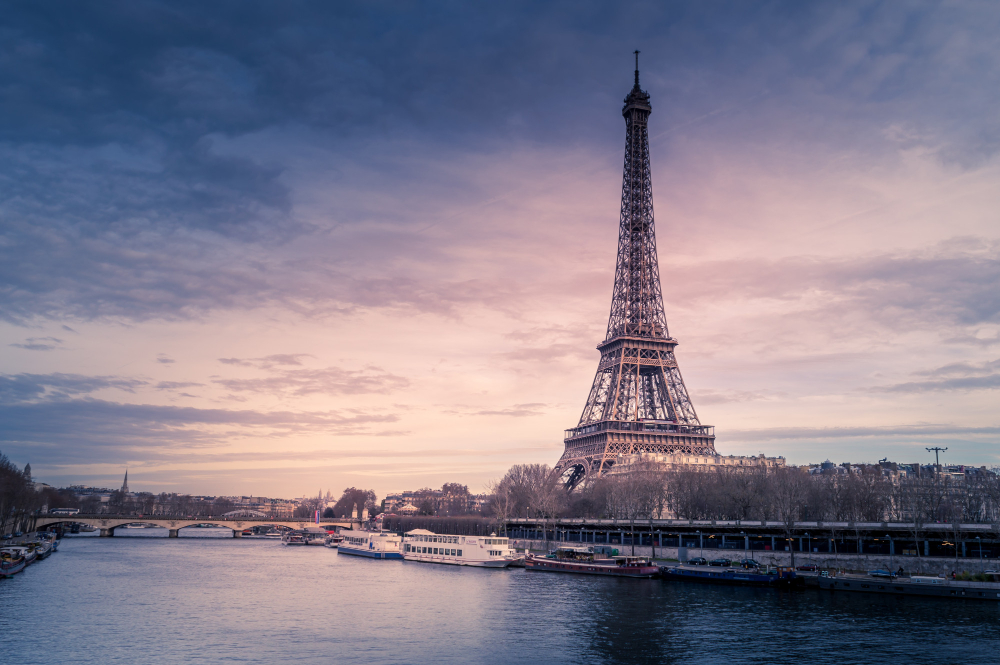 beautiful-wide-shot-eiffel-tower-paris-surrounded-by-water-with-ships-colorful-sky